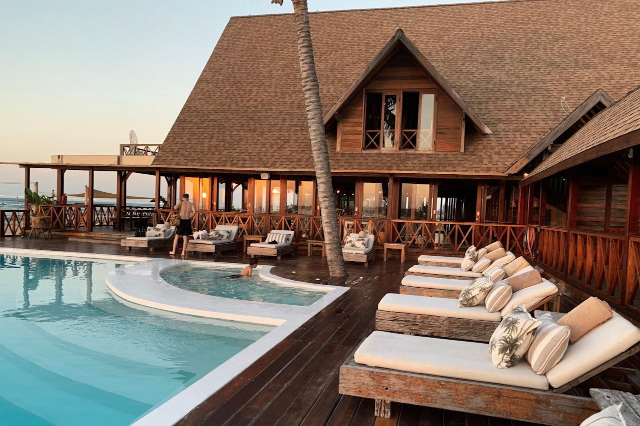 Seaside resort with a pool, deck, and lounge area
